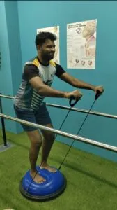 Patient performing supervised squat exercises with weight for knee rehabilitation