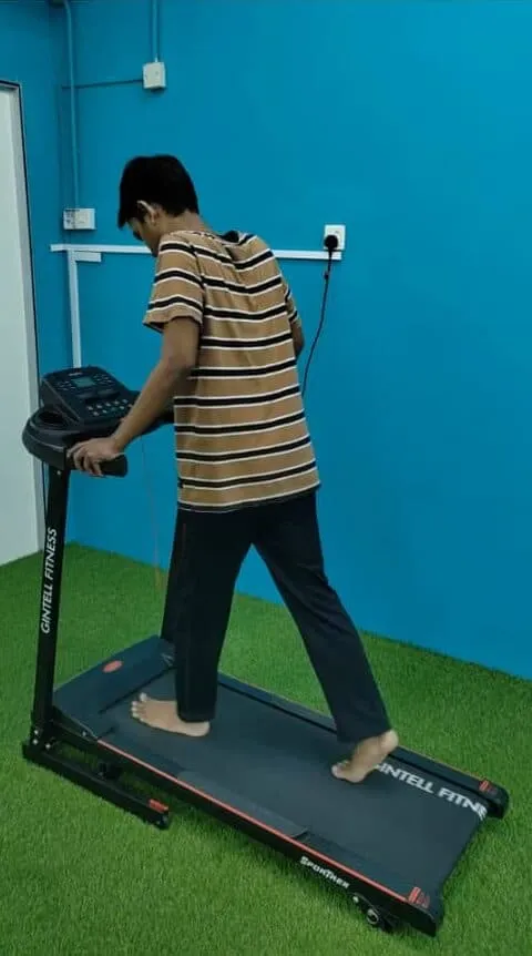 Patient on treadmill during gait rehabilitation physiotherapy session